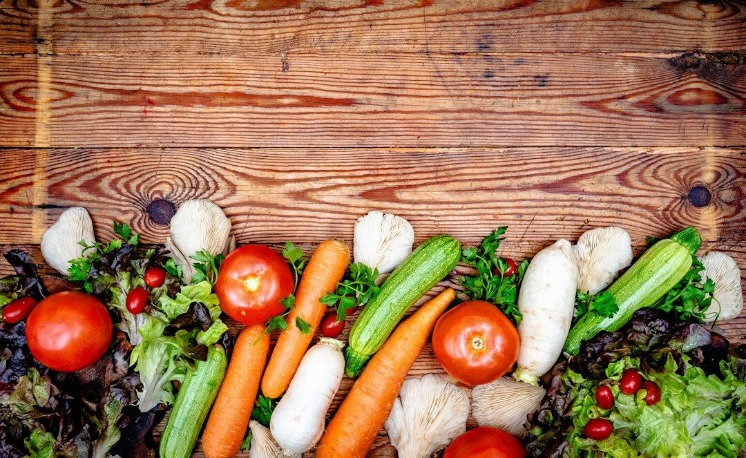 Fresh spring vegetables and herbs on a rustic table